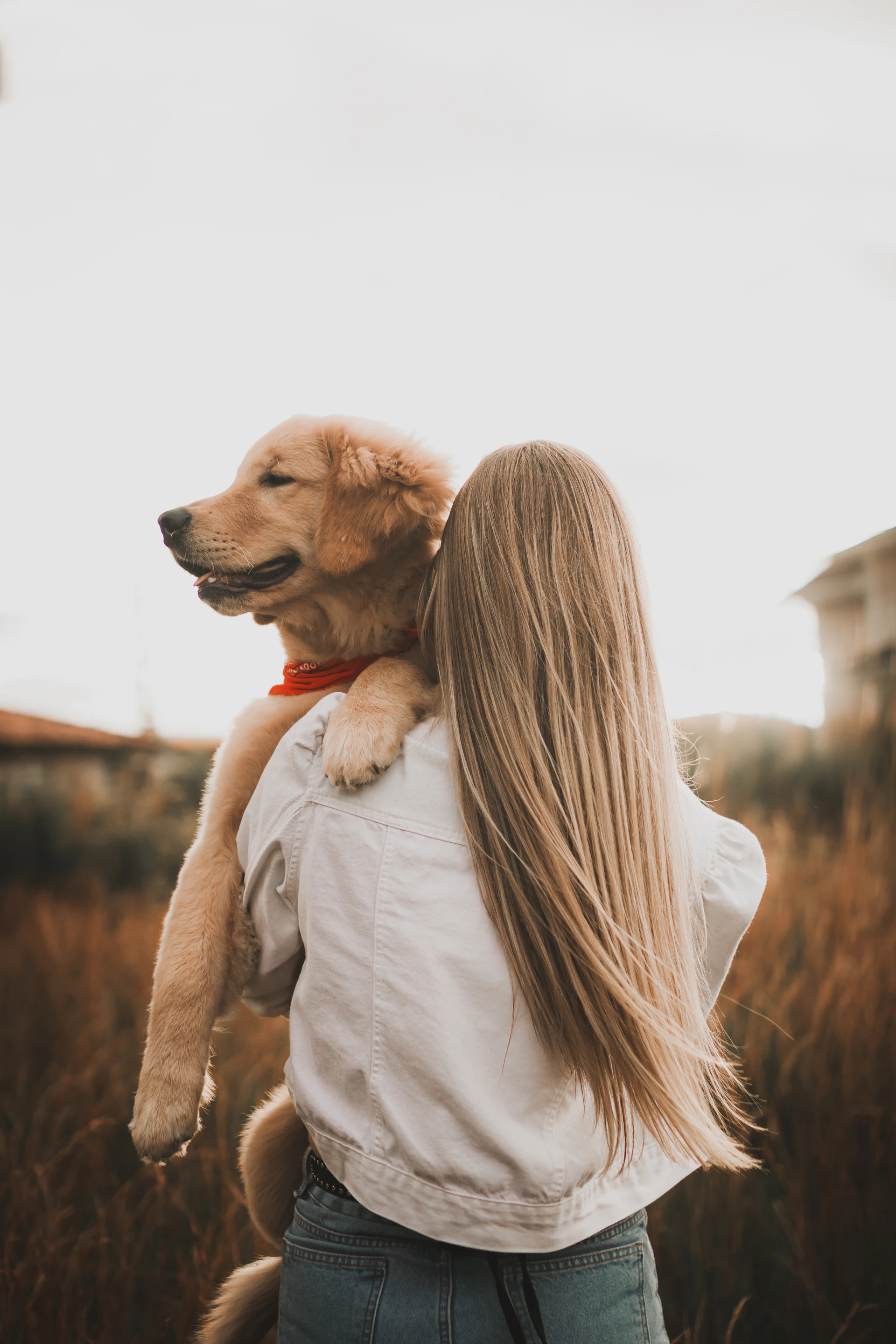 a woman holding a dog in her arms