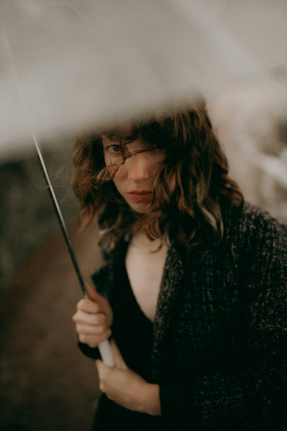 a woman holding an umbrella in the rain