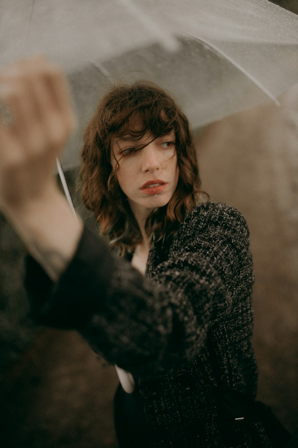 a woman holding an umbrella in the rain