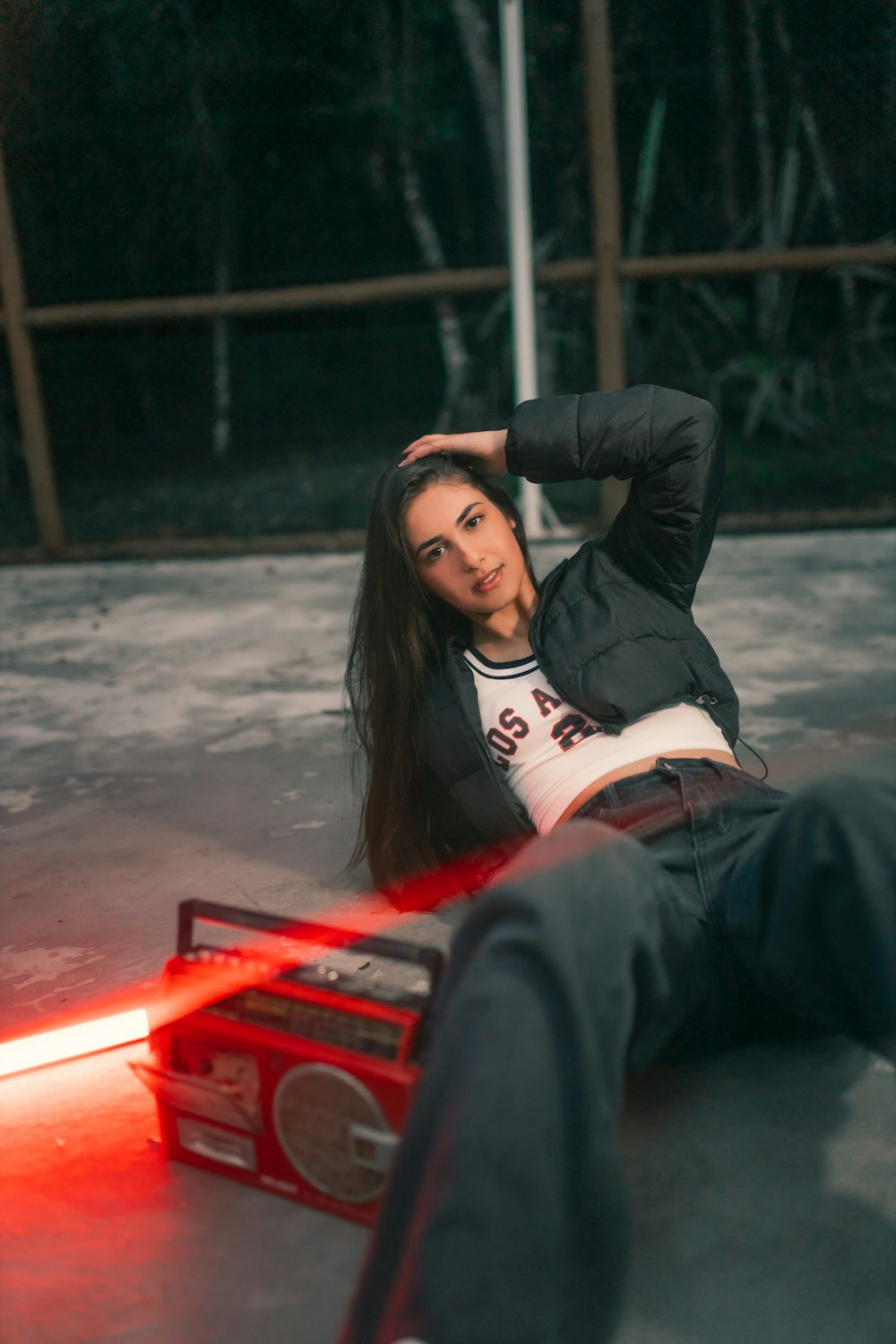 a woman laying on the ground next to a radio