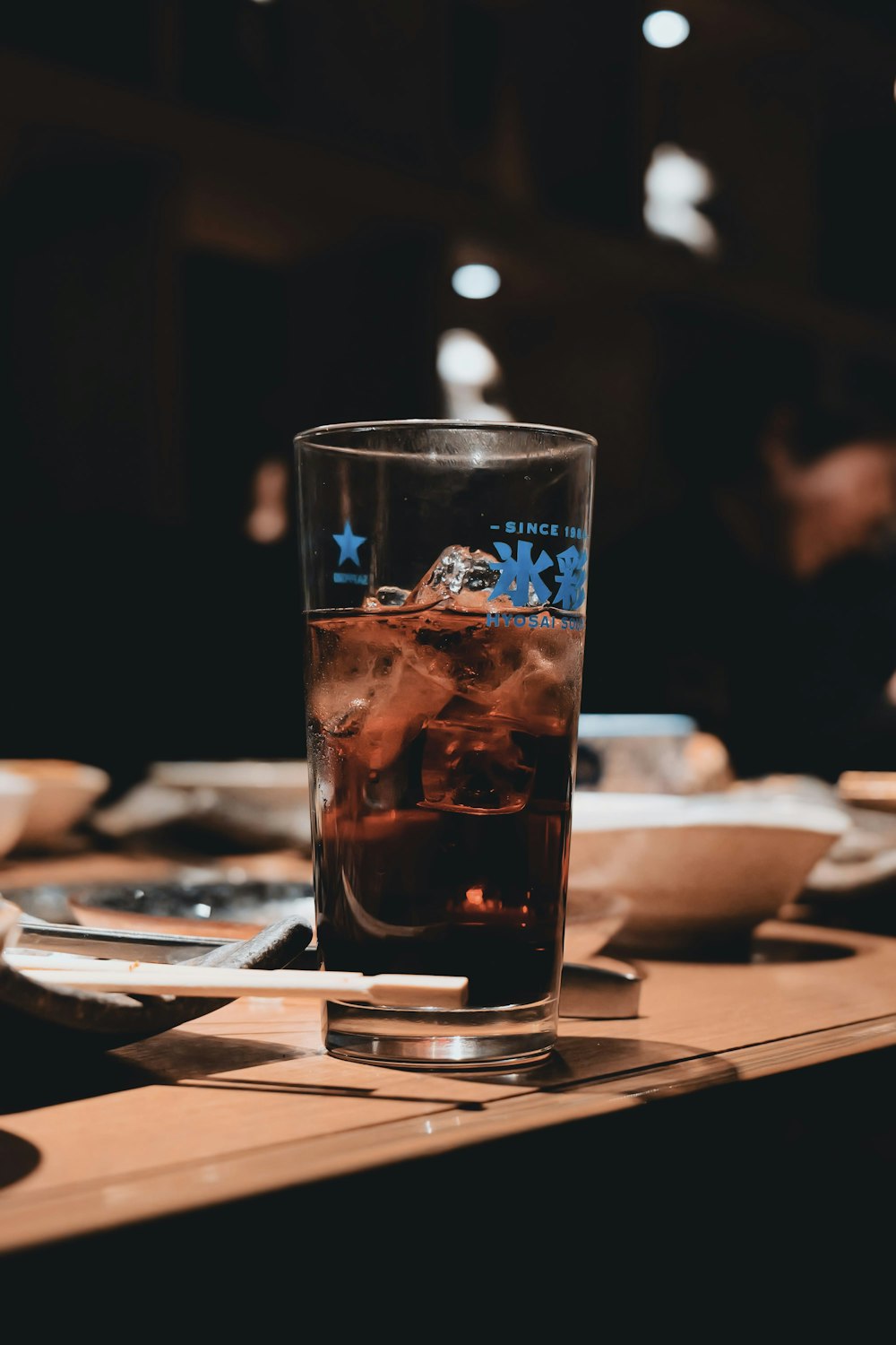 a glass filled with liquid sitting on top of a table