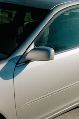 Inspector evaluating the car's exterior for dents and scratches.