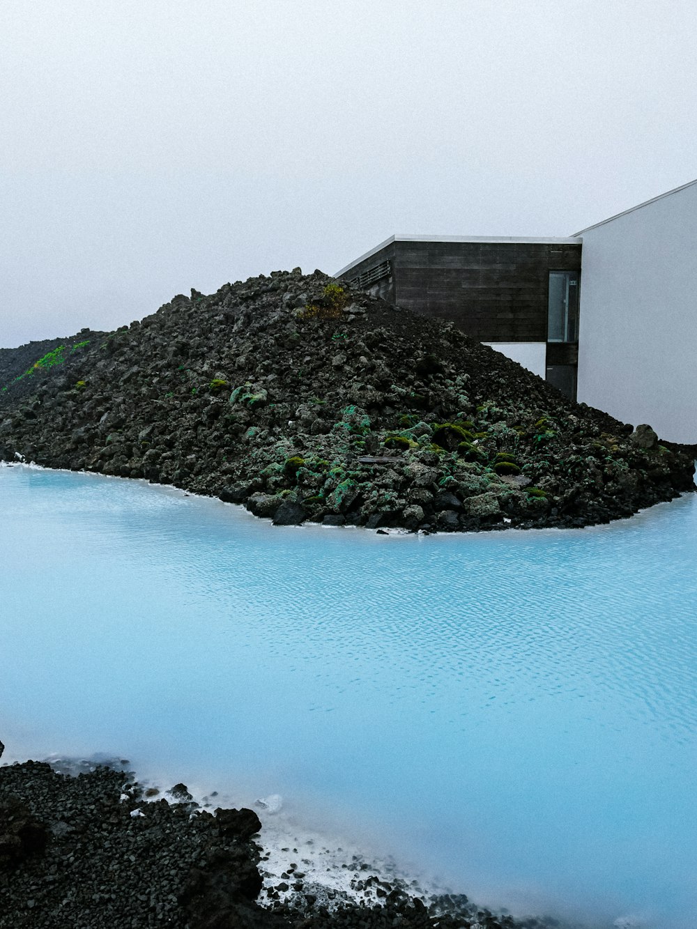 a body of water with a building in the background