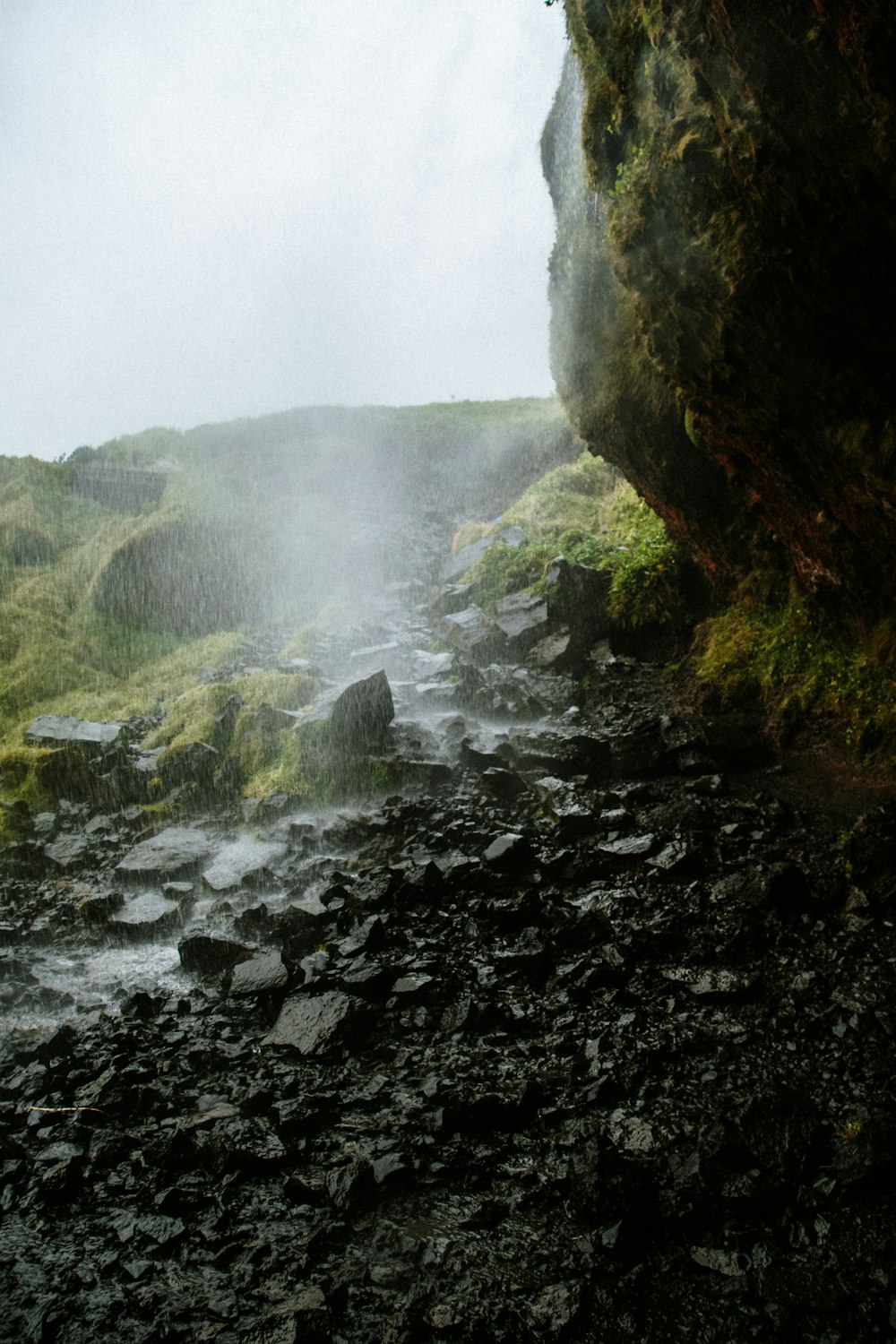 a stream of water coming out of a cave