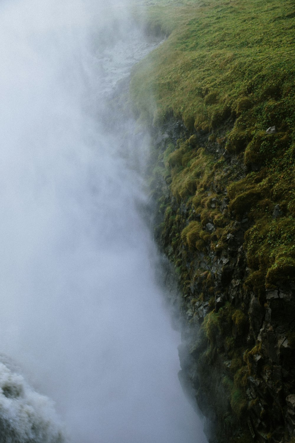 a man is standing on the edge of a cliff