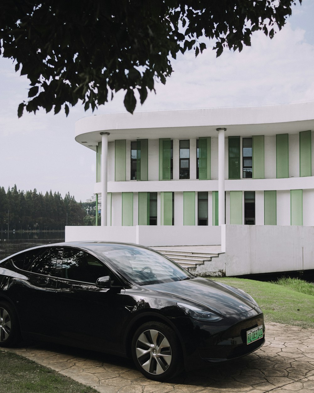 a black car parked in front of a white building