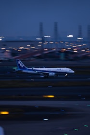 Airplane taking off from airport runway during early morning.