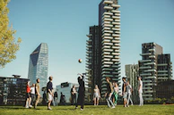 A team-building session with corporate employees engaged in a lively volleyball match outdoors.