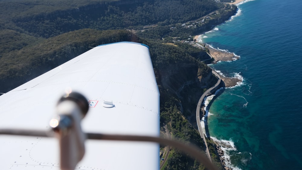 a view of the wing of an airplane over the ocean