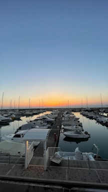 A friendly group of boaters chatting by the marina at sunset.