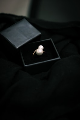 A collection of pearl rings showcased in a stylish box.