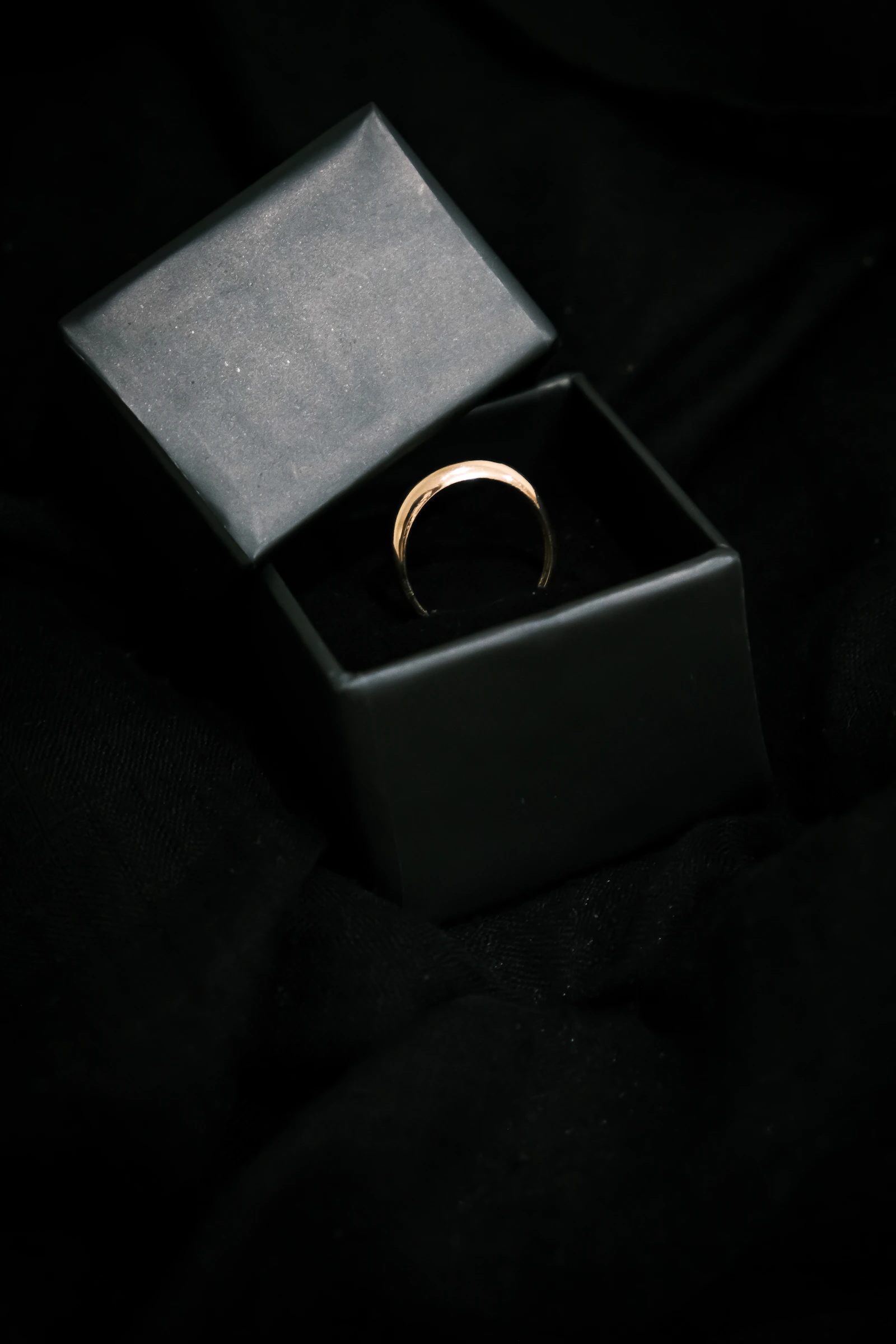 Luxury jewellery ring displayed in a dark presentation setting