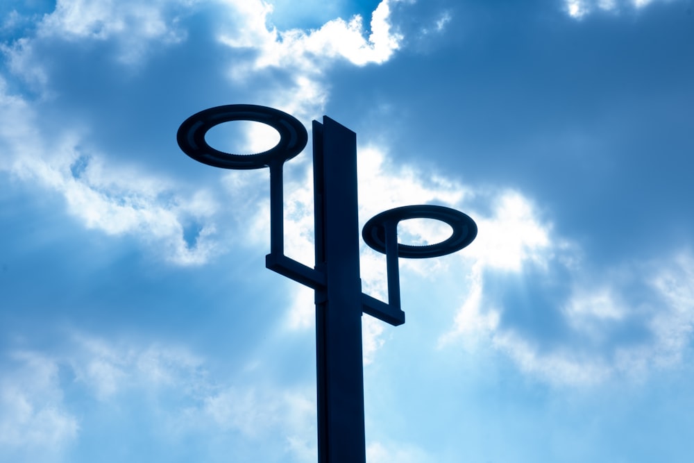 a street light in front of a cloudy blue sky