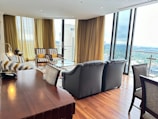 Elegant living room with floor-to-ceiling windows and city view.