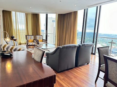 Elegant living room with floor-to-ceiling windows and city view.