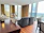 Modern living room with automated curtains opening to a sunny view.