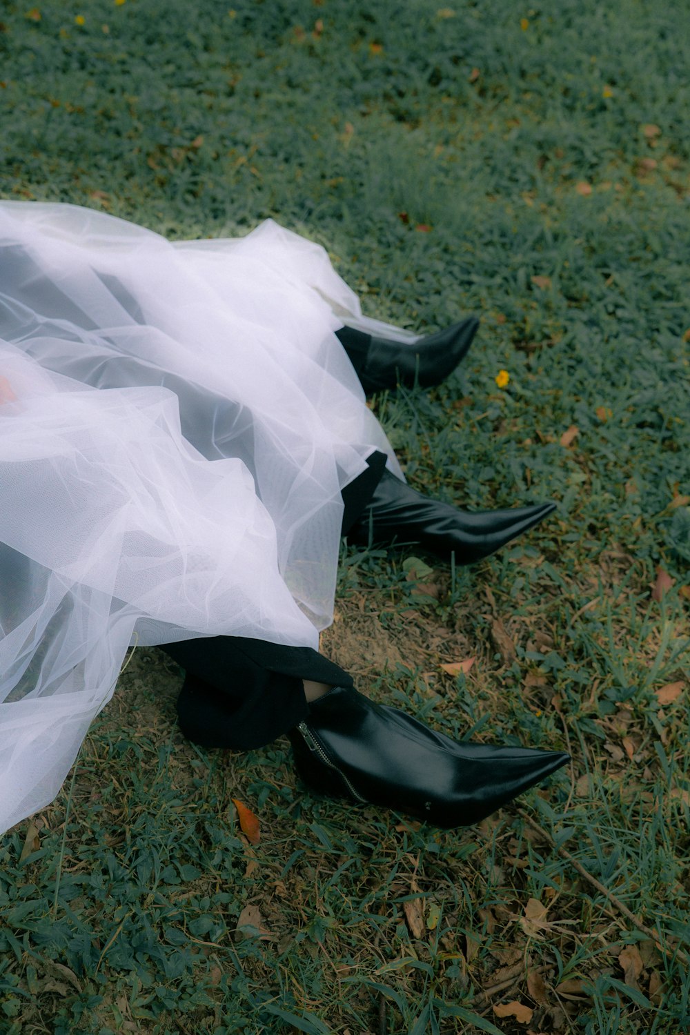 a person wearing black shoes and a white dress