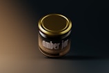 A radiant jar of golden ghee with glowing edges, floating against a dark mode backdrop with curvy borders.