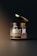 A jar with a metallic dark lid hovers slightly above its container. The jar is labeled 'amber jar' with 'mockup templates' in smaller text underneath. The background is dark with a subtle gradient lighting effect, emphasizing the jar as the focal point.