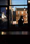 Behind-the-scenes shot of a mobile video shoot in a cozy café with natural light.