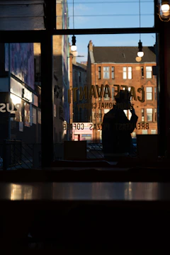Behind-the-scenes shot of a mobile video shoot in a cozy café with natural light.