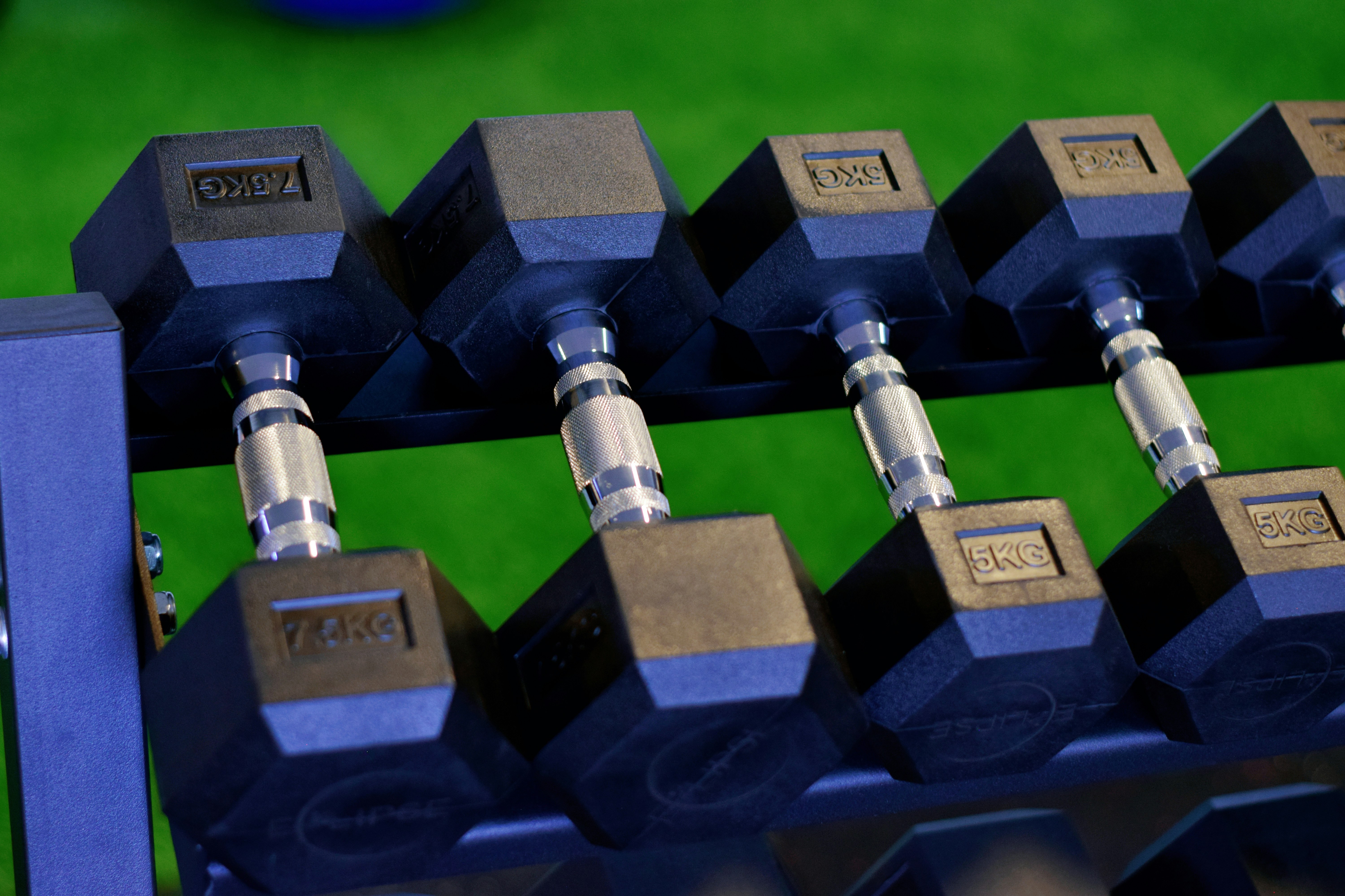 a close up of a bunch of dumbs on a rack