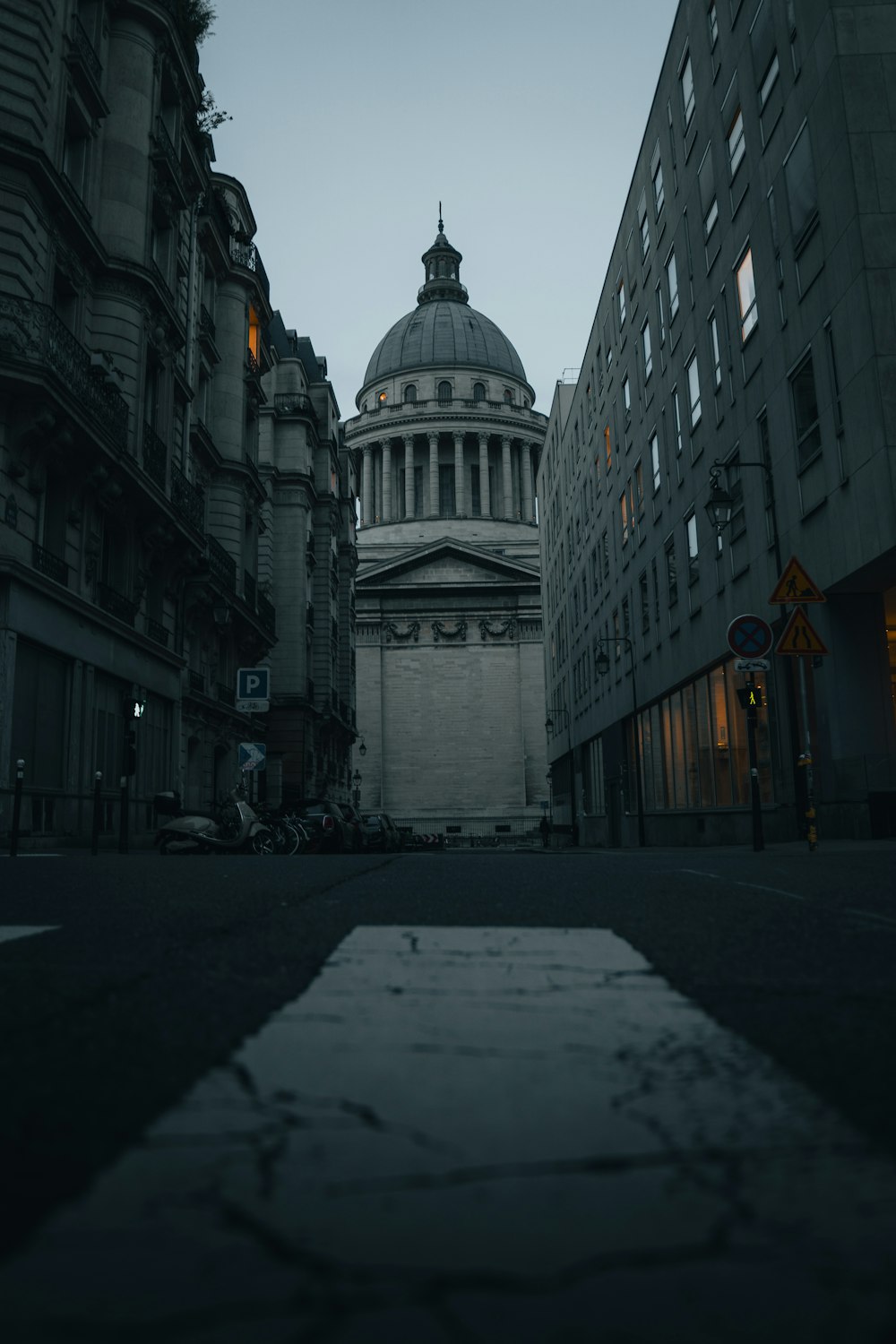 a building with a dome in the middle of a street