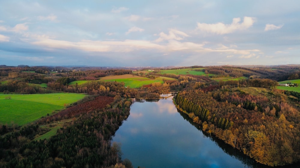 an aerial view of a lake surrounded by trees