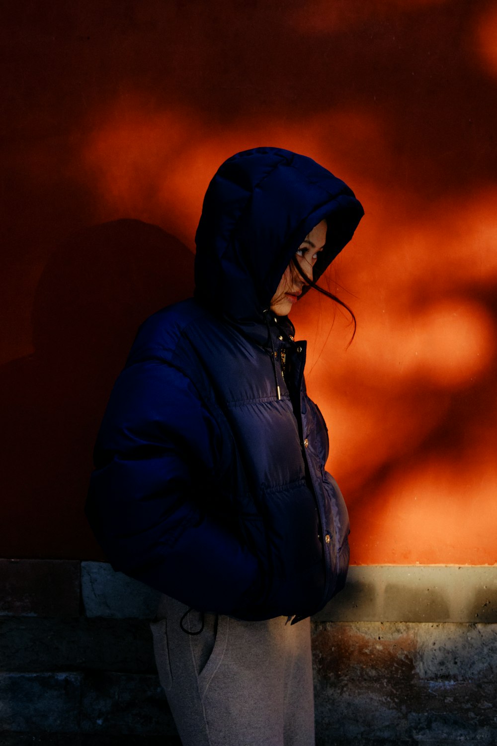 a person standing in front of a red wall