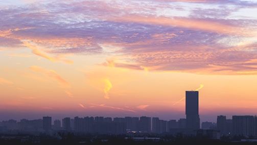 An artistic view of a city skyline at sunset.