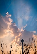 A repaired tower standing tall with fresh paint under a sunset sky.