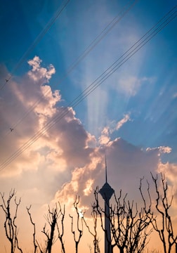 A repaired tower standing tall with fresh paint under a sunset sky.