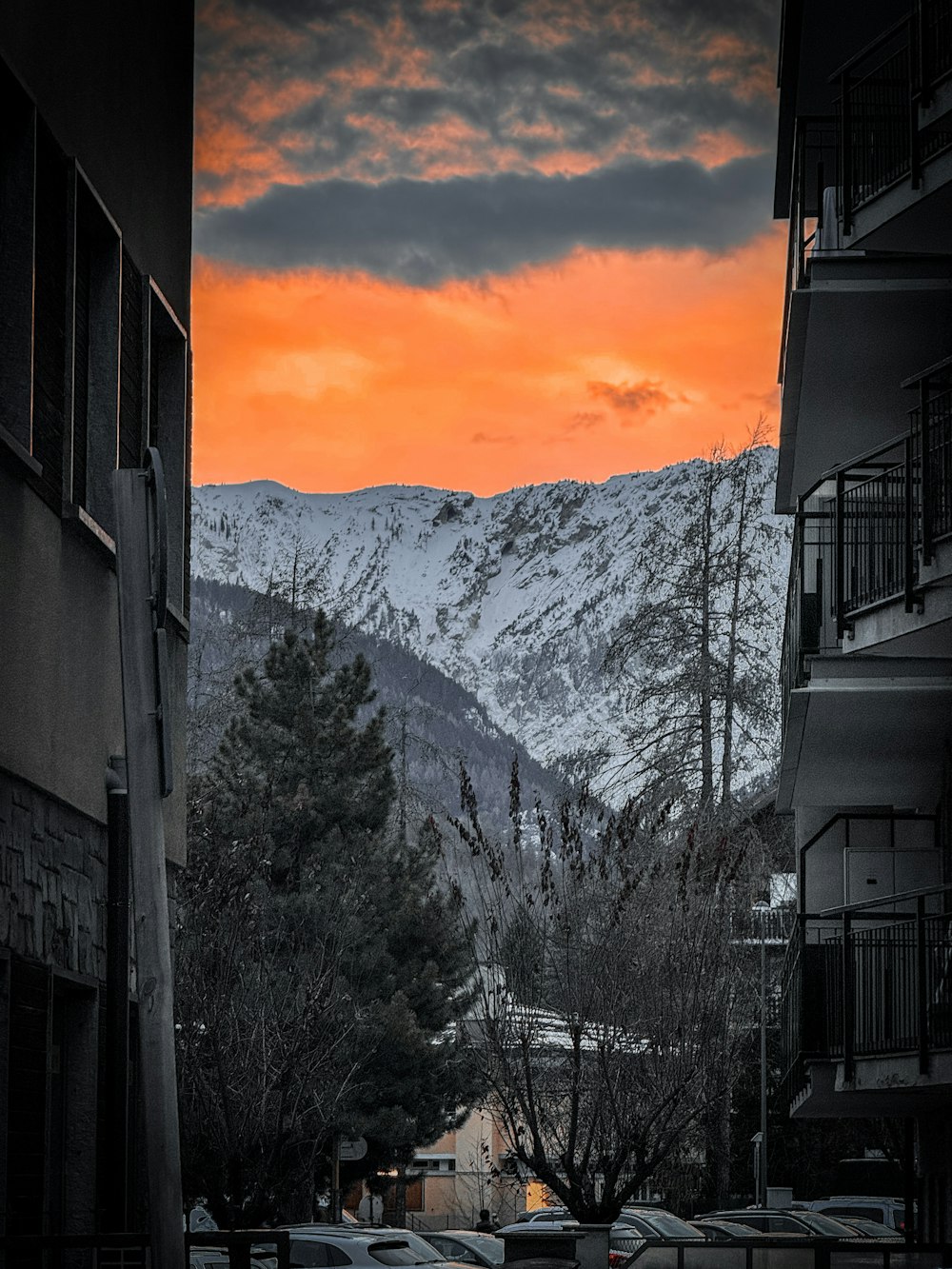 a view of a snowy mountain range from an apartment building