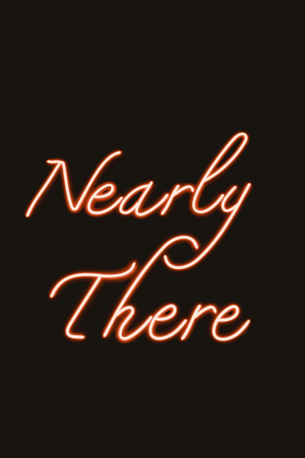 a red neon sign that says nearly there