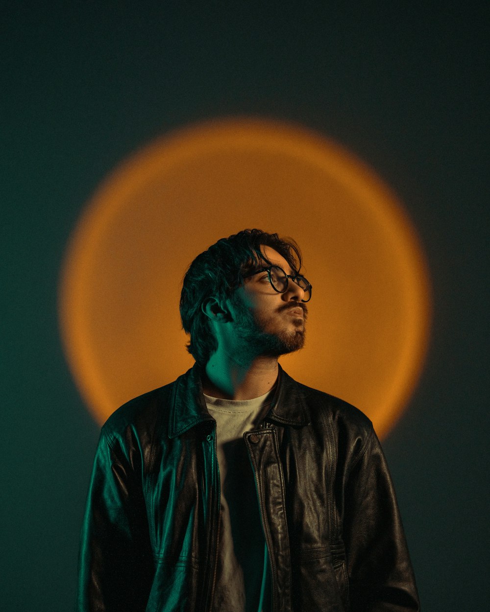 a man wearing a leather jacket and glasses