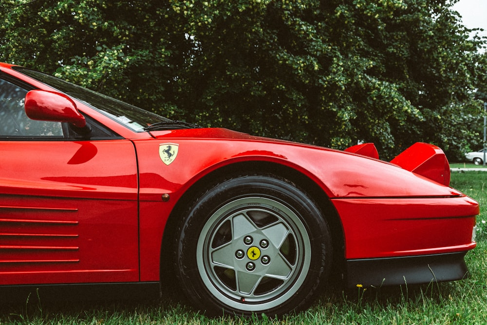 a red sports car parked in the grass