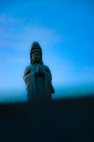 A serene figure sitting peacefully under a glowing sky, symbolizing divine therapy.