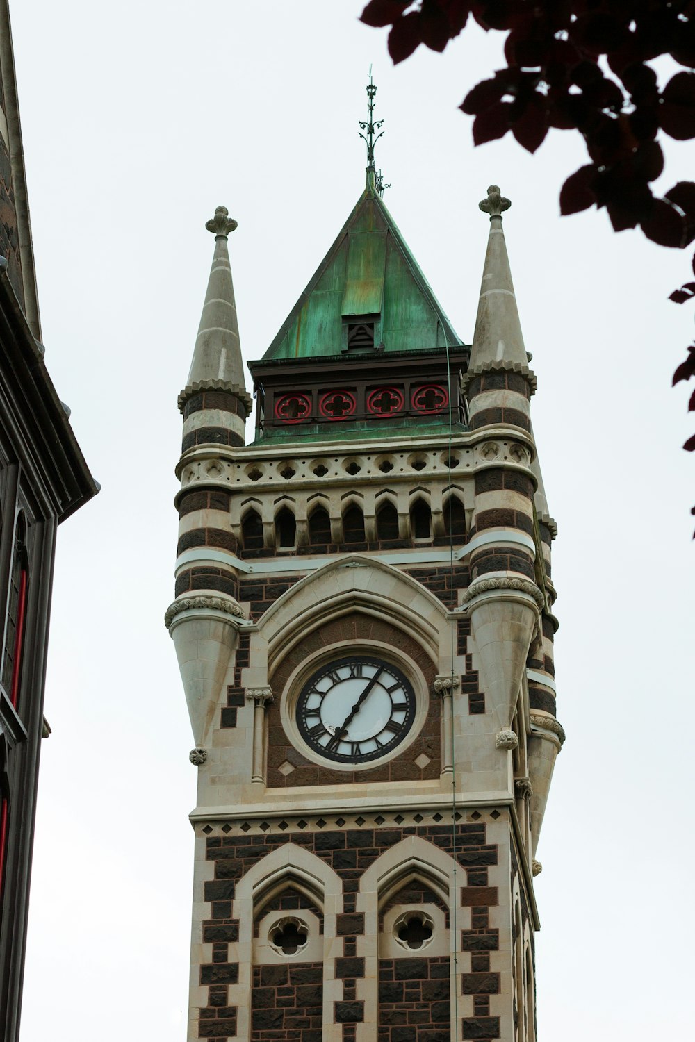 a tall clock tower with a clock on each of it's sides