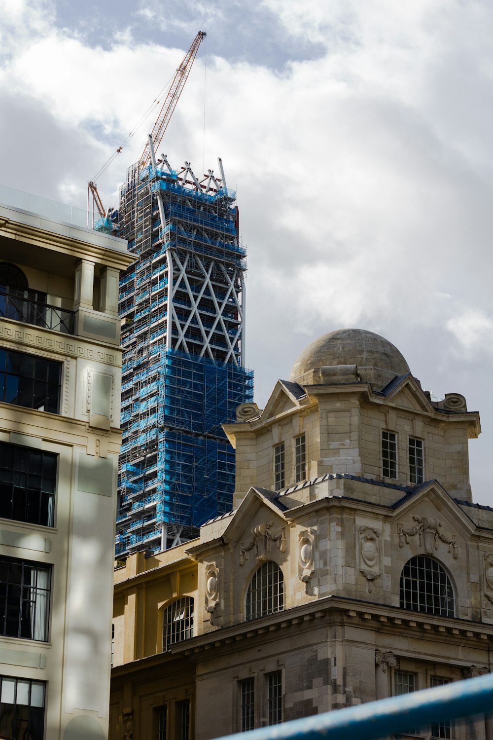 a building under construction with a crane in the background