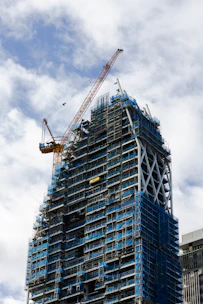 a tall building with a crane on top of it
