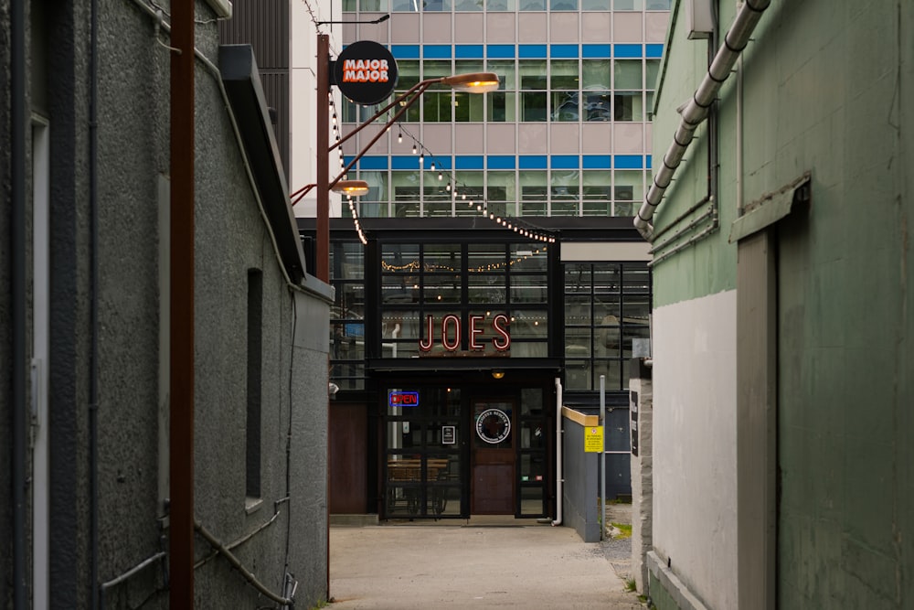 a narrow alley way with a building in the background