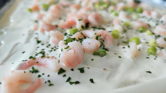 Close-up of a beautifully plated shrimp and grits dish with vibrant colors and elegant presentation.