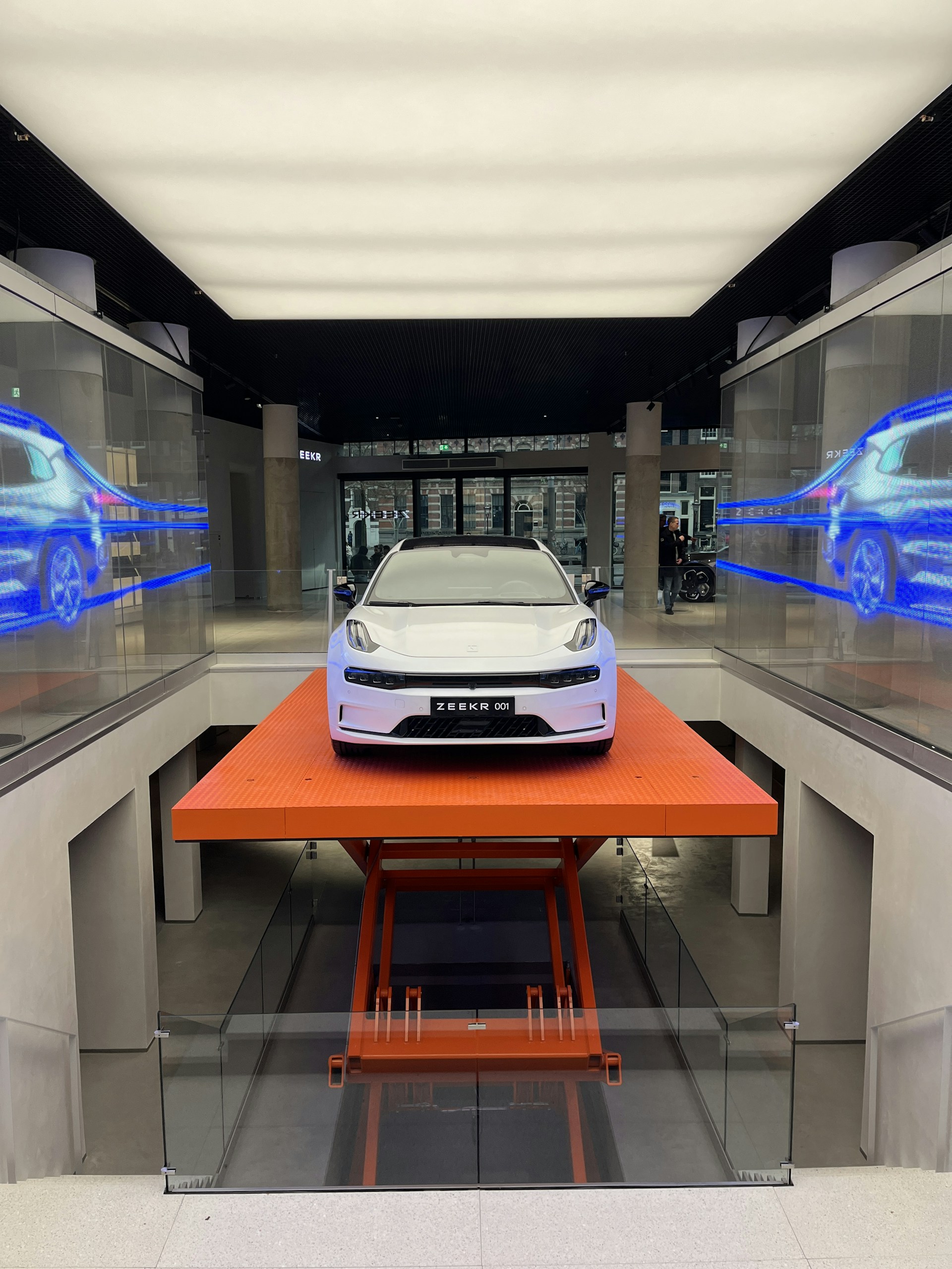 A sleek car lift bathed in warm golden light, highlighting its sturdy design and smooth operation in a modern workshop.