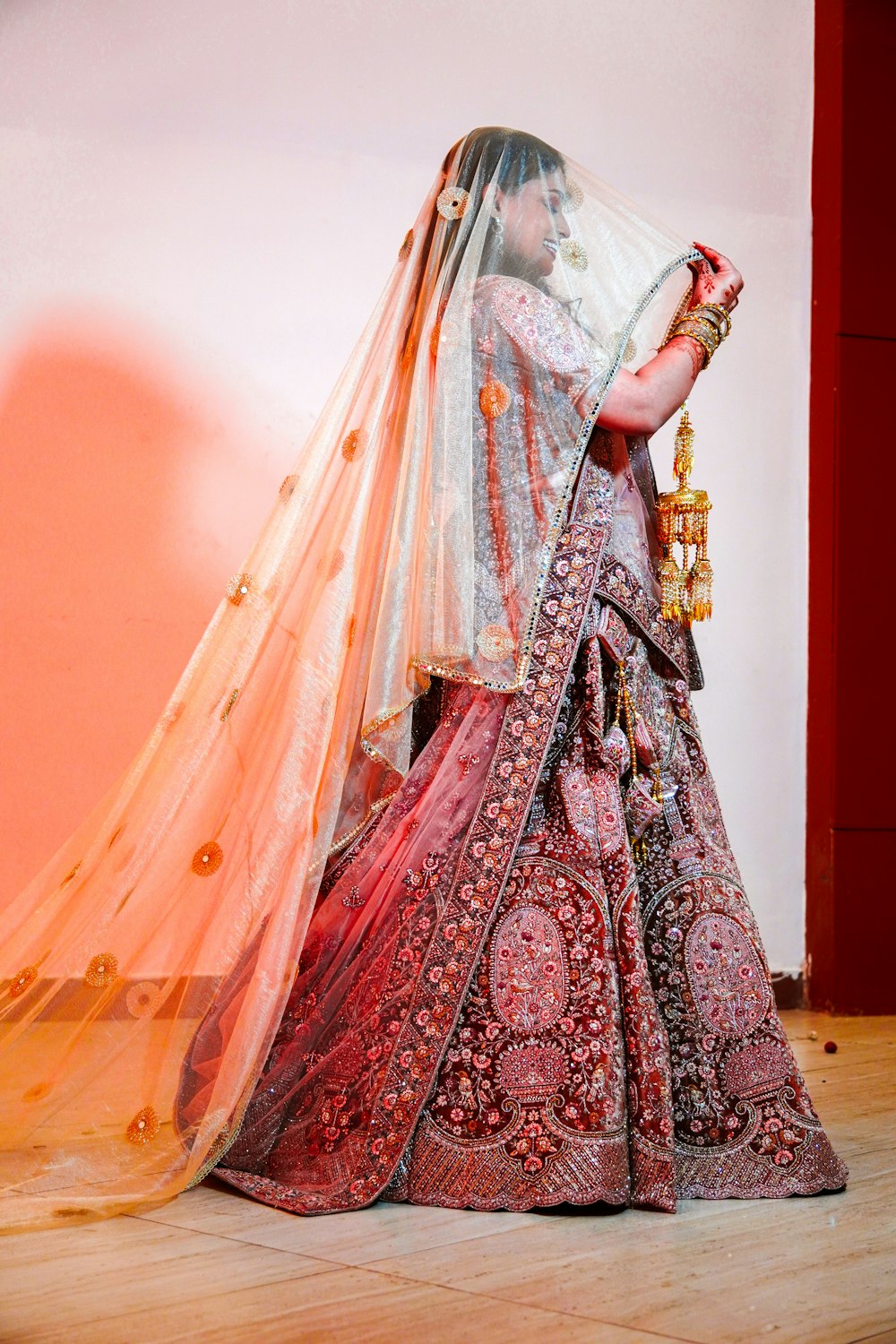 a woman in a red and white bridal gown