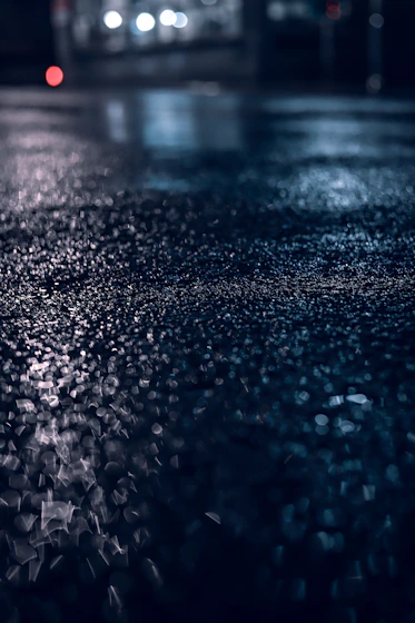 a blurry photo of a wet street at night