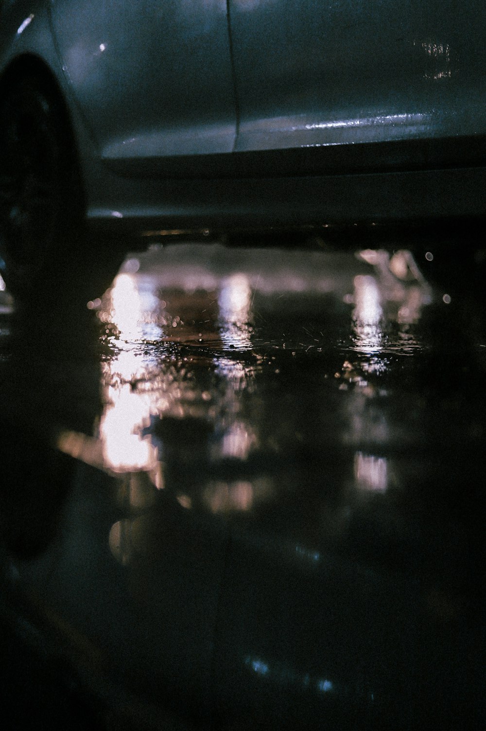 a car parked on a wet street at night