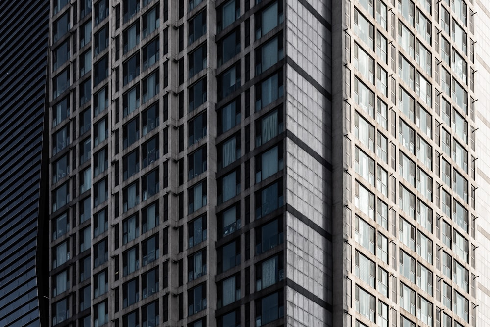 a tall building with lots of windows next to another building