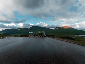 A truck loaded with filming equipment parked at a scenic outdoor location.