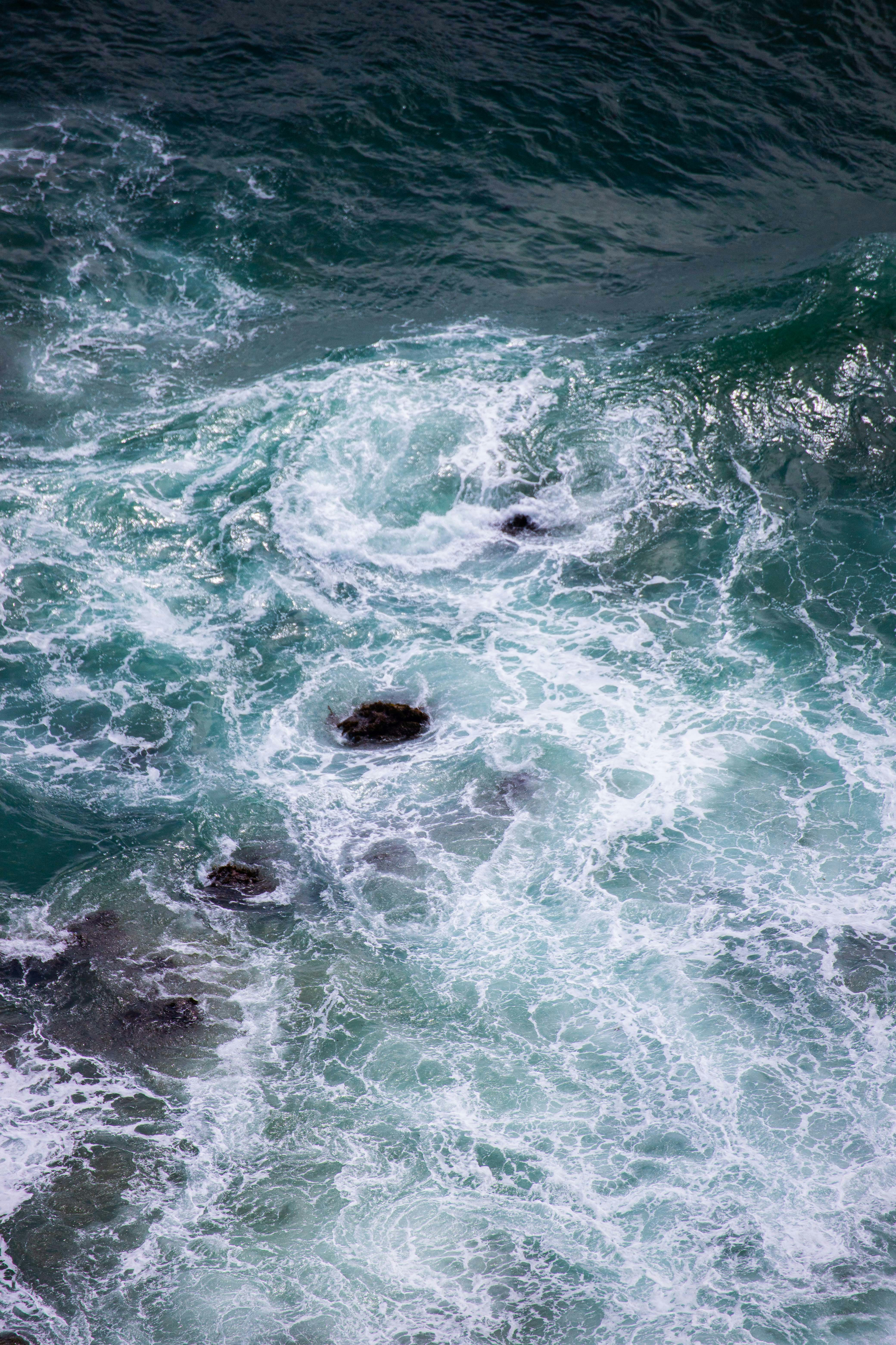 a couple of rocks sitting in the middle of a body of water
