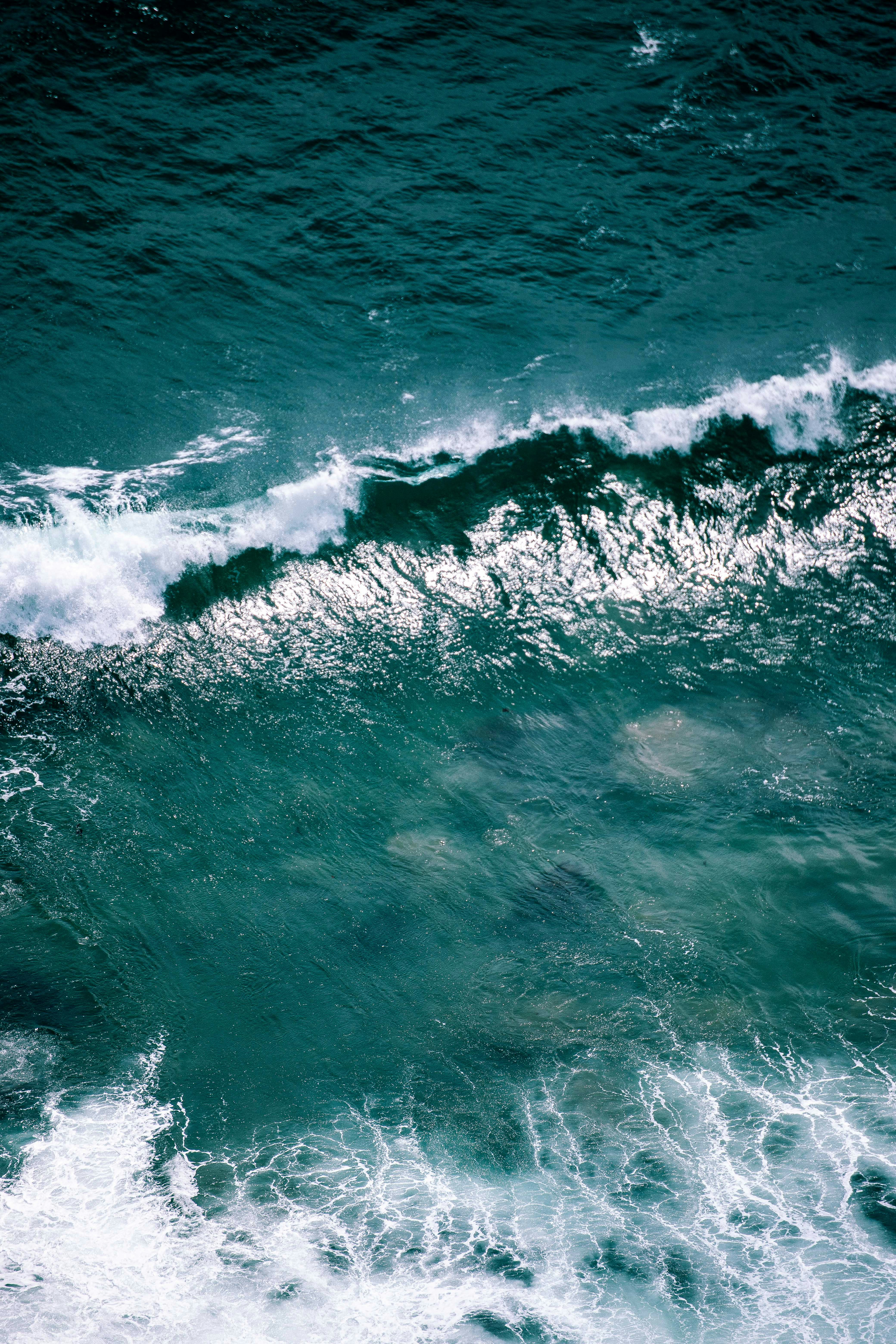 a man riding a wave on top of a surfboard